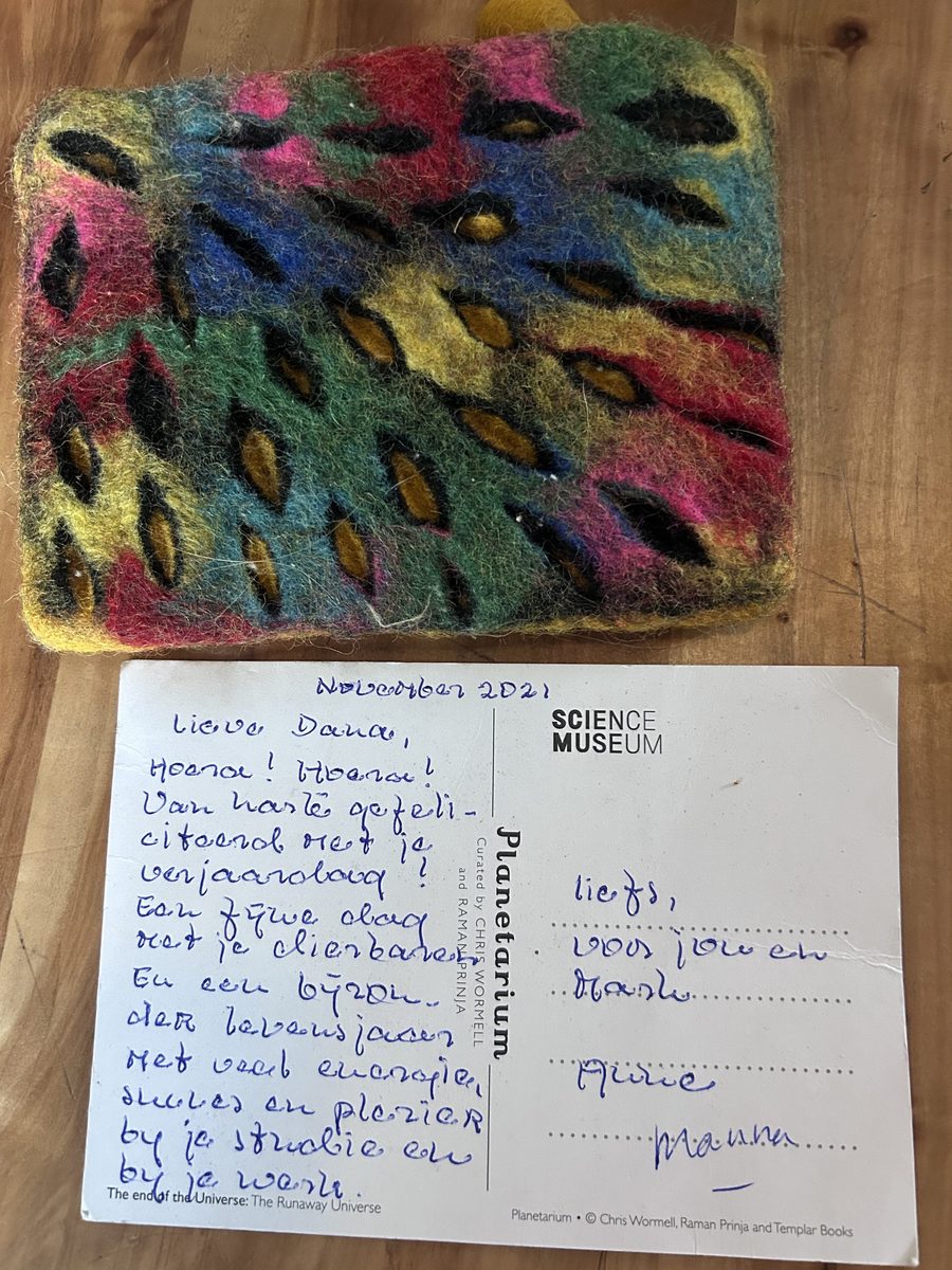 Anne's felt bag in pink, blue, green and yellow wool, with a postcard she wrote